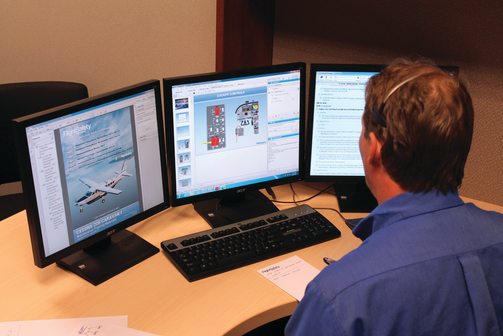 Justin Gray is shown here instructing the Caravan 208 Initial course. Left screen is the FlightSafety Maintenance Training Manual which the client is also able to download; Center screen is instructor&rsquo;s WEBEX interface; Right screen is Cessna Maintenance manuals. Each screen can be shared with the client.