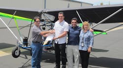 FAA Aviation Safety Inspectors John Soltis (L) and Kym Robbins (R), hand pink airworthiness certificate to Quicksilver Aeronautics principals Will Escutia (white shirt) and Dan Perez at the French Valley Airport.