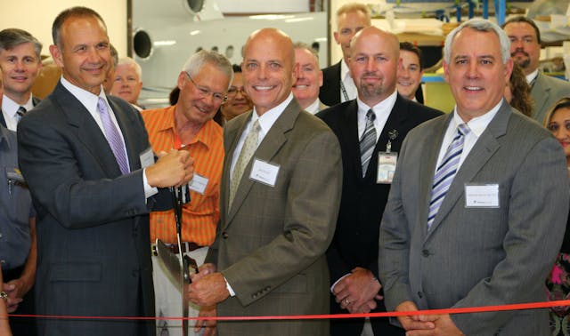 Western Aircraft Celebrates Expansion with Ribbon Cutting Ceremony: Pictured with scissors: President of Western Aircraft Jeff Mihalic, President and CEO of Greenwich AeroGroup Jim Ziegler.