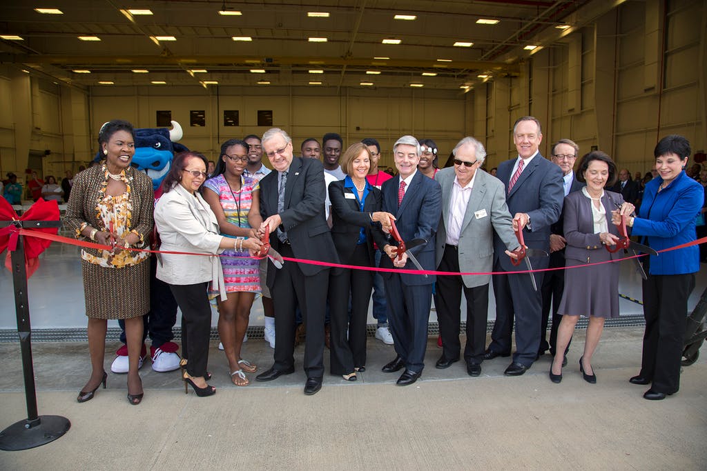 TCC Chancellor Erma Johnson Hadley, left, and TCC Northwest Campus President Elva LeBlanc, far right, are joined by TCC board members, grand opening program participants and Dunbar High School aviation students in cutting the ribbon to officially open Tarrant County College Northwest Campus Center of Excellence for Aviation, Transportation and Logistics (CEATL).