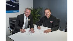Guardian Flight Director of Operations Rick Wysowski and Textron Aviation Senior Vice President of Customer Service Brad Thress sign agreement at NBAA for six orders for the Hawker 400XPR upgrade package.