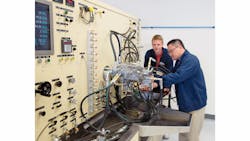 MTU employees at MTU Maintenance Canada with a fuel test rig.
