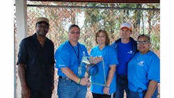 PPG Industries Plant Manager Tom Meyer, second from left, holds the windshield presented to him by employees at the Huntsville, Alabama, aerospace transparencies plant commemorating the facility’s 45th anniversary. Pictured with him are some production em PPG Industries Plant Manager Tom Meyer, second from left, holds the windshield presented to him by employees at the Huntsville, Alabama, aerospace transparencies plant commemorating the facility’s 45th anniversary. Pictured with him are some production em