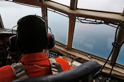 An Indonesian Air Force C-130 crew member scans the horizon during a search operation for the missing AirAsia Flight 8501 over the waters of Karimata Strait on Dec. 29. An Indonesian Air Force C-130 crew member scans the horizon during a search operation for the missing AirAsia Flight 8501 over the waters of Karimata Strait on Dec. 29.