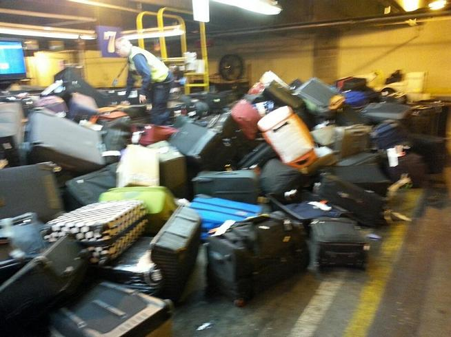 Baggage carousel stands empty while flights continue to arrive. At other times, there were so many bags on the carousel that they were falling onto the floor.