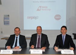 Marco Gredig of Cargologic, Oliver Evans of Swiss WorldCargo, and Alex Hungate of SATS sign the MoU.
