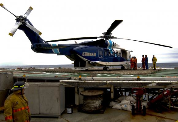 A Cougar Helicopters Sikorsky S-92 helicopter is seen on the helideck of an offshore oil rig on the Grand Banks of Newfoundland in this undated file picture.