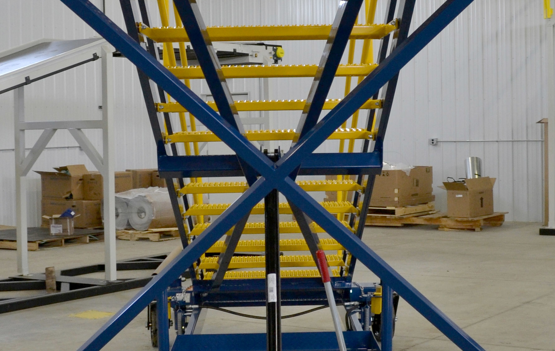 Crew access stairs with automatically locking X-braces increase safety by eliminating a task that could be forgotten by inexperienced ground crews.