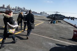 Passengers make their way to a Gotham Air helicopter in New York. Gotham Air offers six-minute flights from lower Manhattan to John F. Kennedy International Airport in Queens, New York.