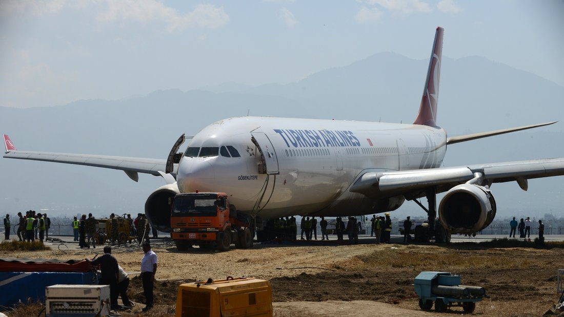 The nose of the Turkish Airlines plane rests on a flatbed tow truck several days after it slid off the tarmac at Kathmandu's international airport.