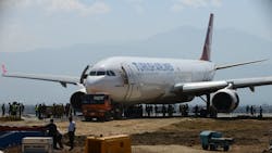 The nose of the Turkish Airlines plane rests on a flatbed tow truck several days after it slid off the tarmac at Kathmandu&apos;s international airport.