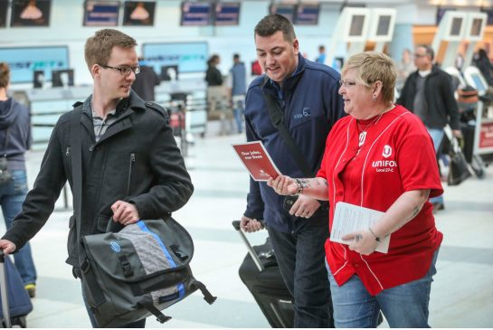 Laura Davis, a national representative of the UNIFOR union, talks with passengers at Pearson International's Terminal 3 about the the passenger service employees who are to lose their jobs at the end of April.