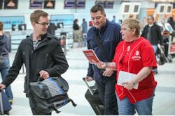 Laura Davis, a national representative of the UNIFOR union, talks with passengers at Pearson International&apos;s Terminal 3 about the the passenger service employees who are to lose their jobs at the end of April.