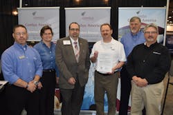 Displaying the Supplemental Type Certificate granted to Comlux America by the FAA are (left to right): Adam Tsakanos of ICG; Kim Stephenson, Senior Manager, Aftermarket Sales, L-3 Corporation; CoryKolman, West Coast Regional Sales Manager for Comlux; Vic Hagner, Avionics Manager for Comlux; Tim Rayl, Senior Vice President, Sales and Marketing for ICG; and Bruce Bunevich, Great Lakes Regional Sales Manager for Universal Avionics.