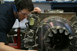 A Honeywell Aerospace technician wearing the Vocollect headset conducting an incoming inspection on an APU.
