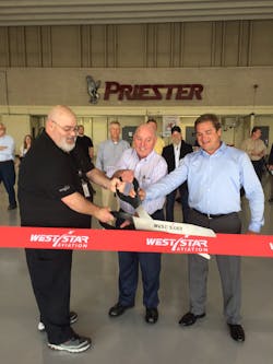 From L to R: Thomas Hilboldt (black shirt), Satellite Manager KPWK, West Star Aviation; Charlie Priester, Chairman of Priester Aviation; and Eric Kujawa, General Manger ALN, West Star Aviation performing the ribbon cutting at the West Star&rsquo;s newest satellite location in Chicago, IL.