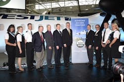 Government officials along side executives and staff from Bombardier and WestJet