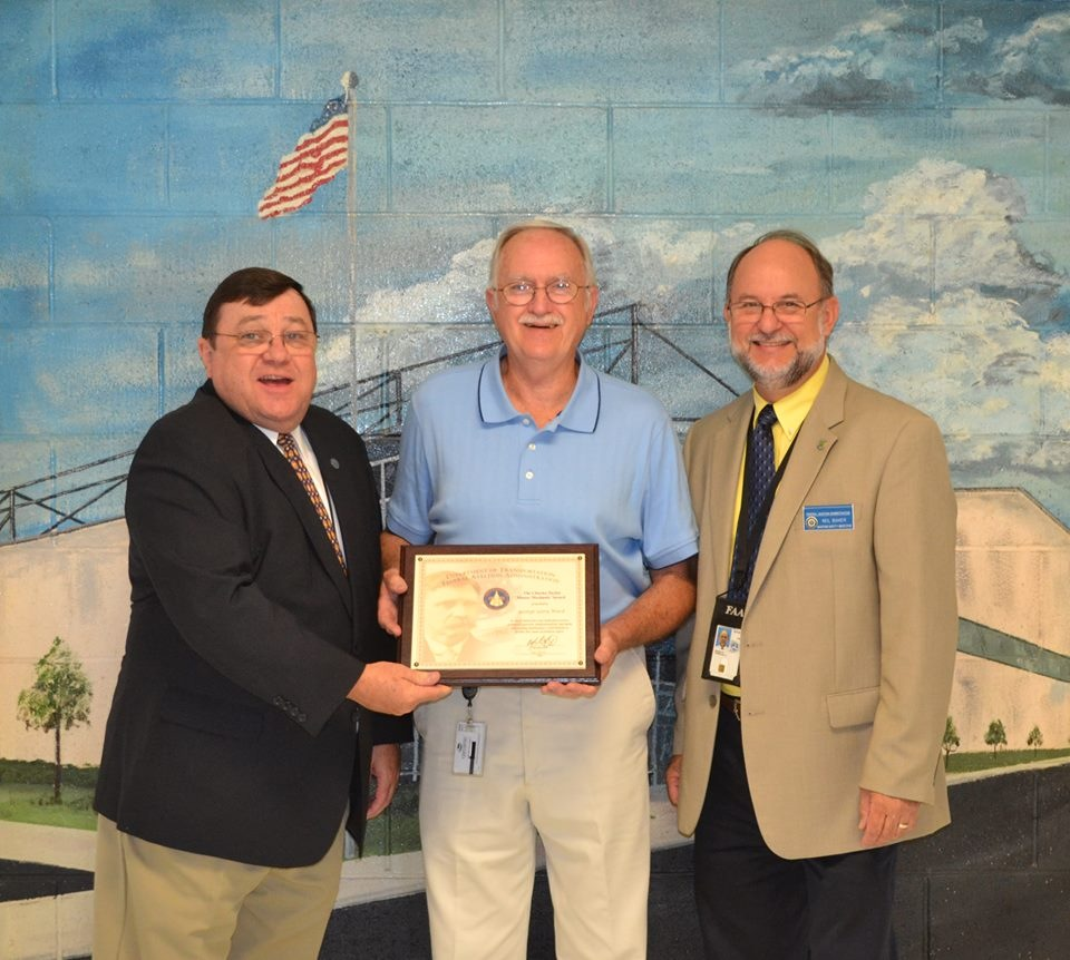 Michael J. Mullaney, FAA Southern Region (left) and Neil Baker, Maintenance Inspector, South Carolina FSDO (right) present Gary Ward with the Charles Taylor Master Mechanic Award.