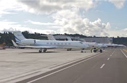 Lined up for a morning departure at Boeing Field (KBFI) in 2013, a gaggle of Gulfstreams flanked by a lone Falcon 900 in the distance are positioned on the ramp adjacent the taxiway. Airside improvements such as hangars and FBO facilities are height limited to FAR 77 protected areas, thus situated behind the aircraft. Lined up for a morning departure at Boeing Field (KBFI) in 2013, a gaggle of Gulfstreams flanked by a lone Falcon 900 in the distance are positioned on the ramp adjacent the taxiway. Airside improvements such as hangars and FBO facilities are height limited to FAR 77 protected areas, thus situated behind the aircraft.