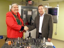 Dr. Gail Carberry, President of QCC (l) and Mr. Bob Hellinger, President of Emuge Corp. (r) with a sampling of Emuge Tools in foreground.