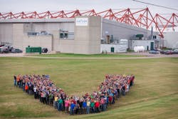 Vector employees in a V formation outside the Summerside facility.