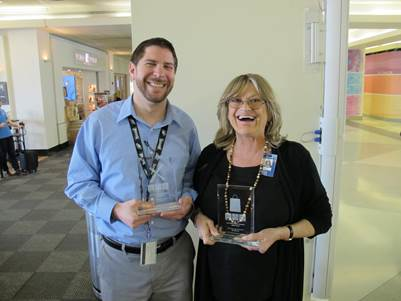 Tom DiStefano, manager of Cibo Bistro & Wine Bar, and Daniela Biscaro, manager of Fire & Ice, posing with their trophies