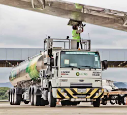 An Air BP tanker driver under the wing of an A320 aircraft at Galeao Airport in Rio de Janeiro, Brazil