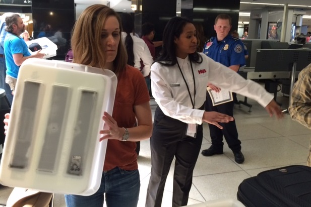 Contractor (in white shirt) training today with TSA security officer.