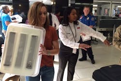 Contractor (in white shirt) training today with TSA security officer. Contractor (in white shirt) training today with TSA security officer.