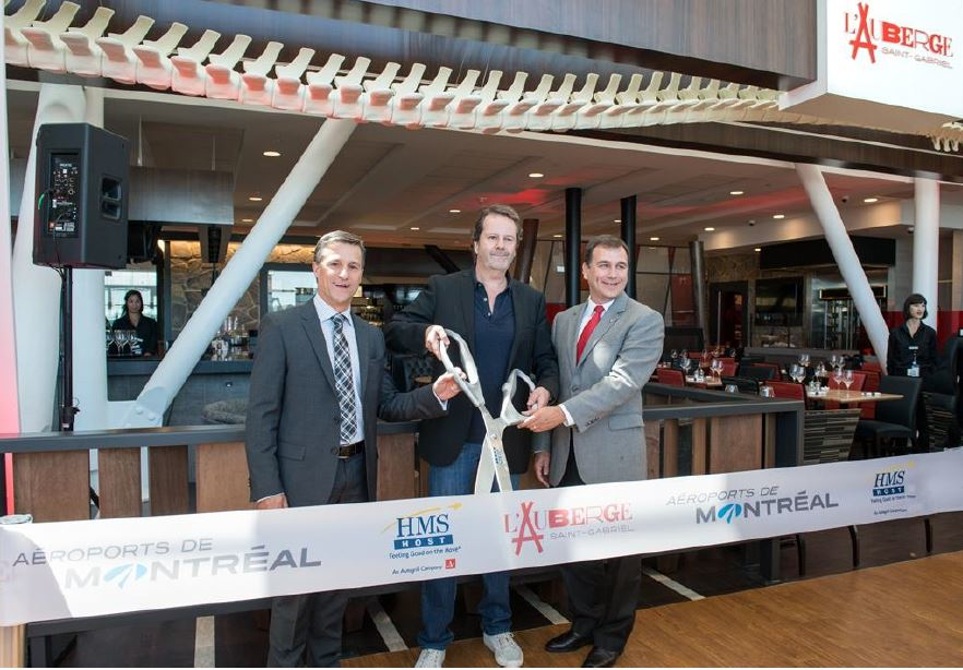 Cutting the ribbon, from left to right, Charles A Gratton, vice president, real estate and commercial services, A&eacute;roports de Montr&eacute;al; Marc Bolay, co-owner of L&rsquo;Auberge Saint-Gabriel; Stephen Douglas, vice president of business development at HMSHost.