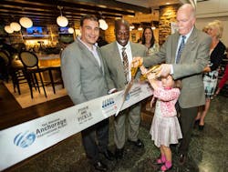 Cutting the ribbon, left to right: Stephen Douglas, vice president of business development, HMSHost; Javier Robinson, concessions manager, Ted Stevens Anchorage International Airport.; John Parrott, airport manager, Ted Stevens Anchorage International Airport. Cutting the ribbon, left to right: Stephen Douglas, vice president of business development, HMSHost; Javier Robinson, concessions manager, Ted Stevens Anchorage International Airport.; John Parrott, airport manager, Ted Stevens Anchorage International Airport.