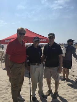 Sheltair s Warren Kroeppel, left, and William McShane, right, greet Dr Roscoe Brown at the Bethpage Federal Credit Union Airshow at Jones Beach.