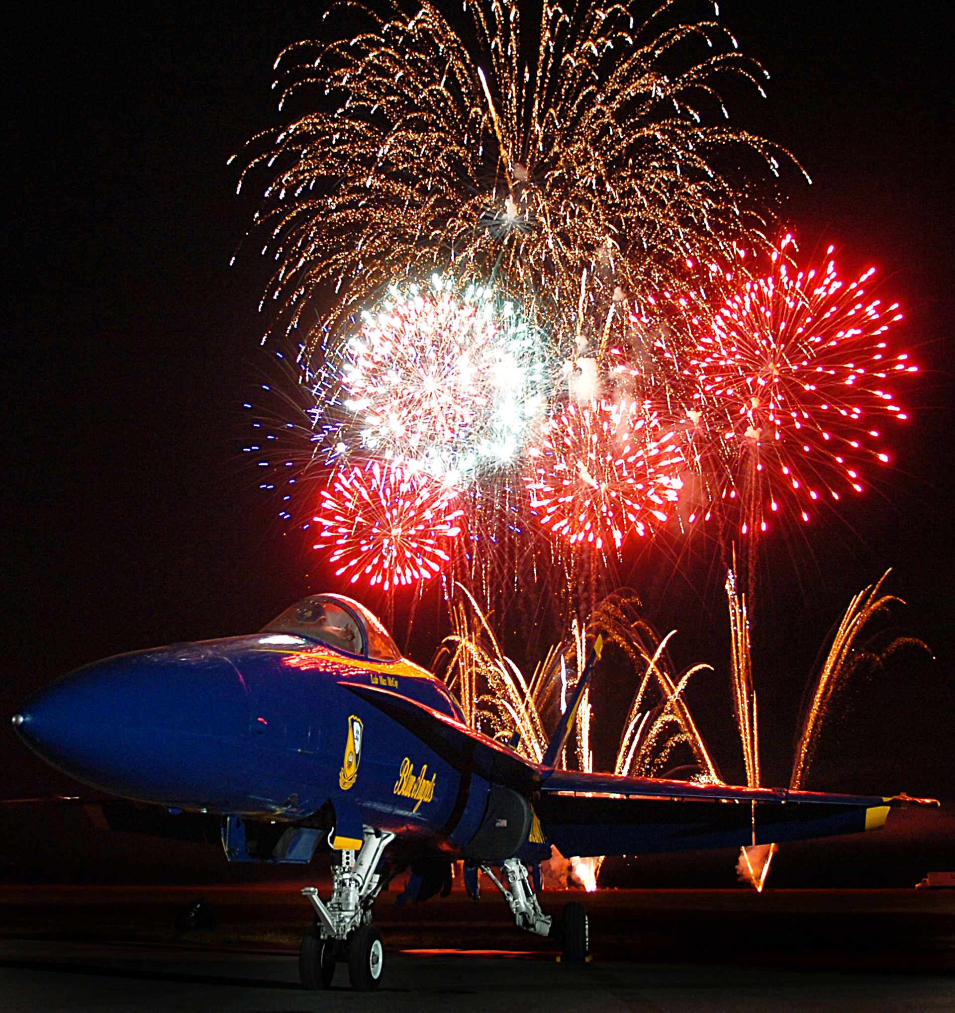 Us Navy 050931 N 9769 P 001 Fireworks Explode And Highlight An F A 18 A Hornet Assigned To The U s Navy Flight Demonstration Team The Blue Angels At The Mid South Air Show At The Millington Municipal Airport 57769a0c89ff5
