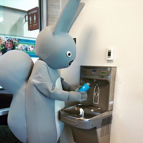Albert, the Sustainability Squirrel using the refill station.