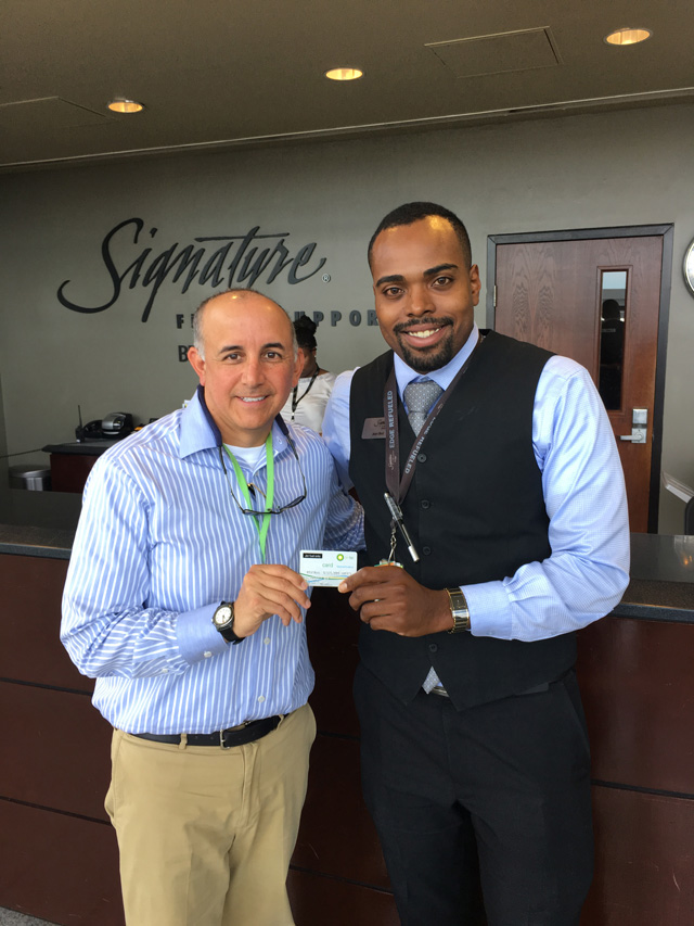 From left to right, a representative of Cox Enterprises' Flight Department, one of the first Air BP Sterling Card holders to use the new service, marks the occasion with Signature's Jean Best, Customer Lead at IAD airport, Washington.