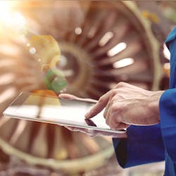 An engineer checks data from a Rolls-Royce engine An engineer checks data from a Rolls-Royce engine
