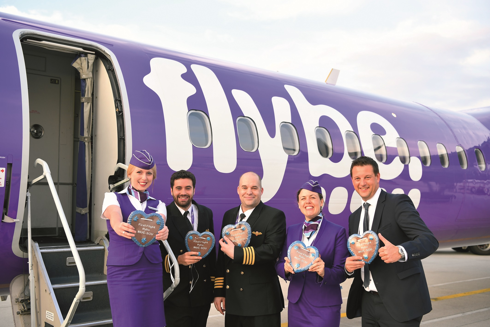 To celebrate the inaugural flight to Southampton, the Flybe crew were presented with traditional gingerbread hearts by Munich Airport's airline liaison manager Martin Laubenthal (right).
