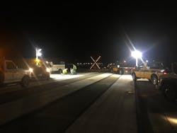 Airfield Maintenance employees working on an in-pavement flush mounted runway touchdown zone light. Airfield Maintenance employees working on an in-pavement flush mounted runway touchdown zone light.