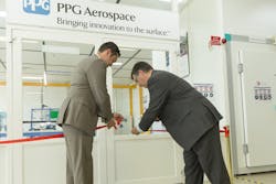 Daniel Bencun, left, PPG Aerospace coatings segment manager for the Europe, Middle East and Africa region, and Pascal Vanhamme, PPG manager of the Marly, France, coatings research center, cut the ribbon during ceremonies to open a new laboratory and inaugurate an AEROCRON&trade; electrocoat aerospace primer pilot system.