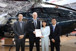 Diana Chou, chairwoman of Aerochine companies, receives the certificate of Authorized Customer Service Facility from Bell Helicopter.