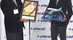 Interjet CEO Juan Luis Garza and CDA Deputy Commissioner Alex Leon exchange gifts at the airline's launch at O'Hare.