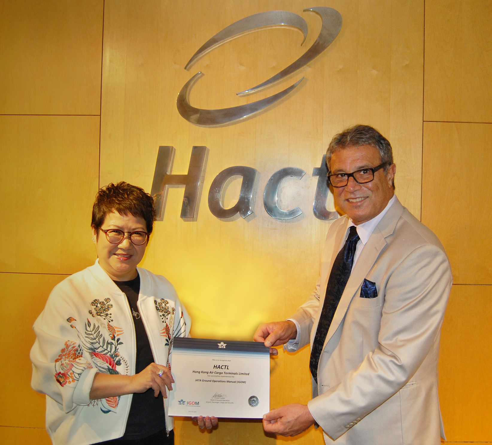 Hactl Finance Director Amy Lam receives the IGOM certificate from IATA Head of Ground Operations Joseph Suidan.