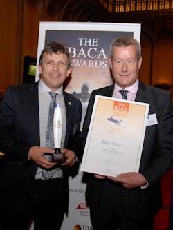 Peter Alfred, Operations Director at Transvalair UK hands the Best Cargo Airline award to Jota Aviation Managing Director Andy Green (left).
