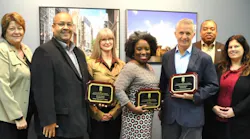 Airport representatives with ACI-NA award plaques. From left to right, Debbie Wodrich, Unison Consulting; Marc Wright, CDA; Patricia Grzyb, Unison Consulting; Tiffany Green, CDA; Glen Ryniewski, CDA; Horatio Watson, CDA; Angie Kocerka, CDA.