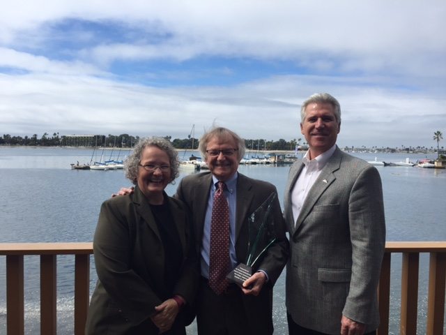 Mary Vigilante, left, of Synergy Consultants, along with John Johansen of Ted Stevens Anchorage International Airport (not pictured) nominated Ryk Dunkelberg, center, for the award. Jim Elwood , right, director of aviation for Jackson Hole Airport and a longtime client and friend of Ryk&rsquo;s, was asked to present the award.