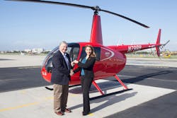 University of North Dakota&rsquo;s Don Dubuque Receives Keys to New R44 Cadet from Robinson&rsquo;s Monica Campos.