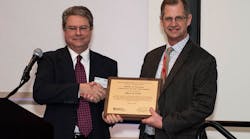 Consultant of the Year: Mark Noel (left) presents the award to Ron Engel, group leader, Mead &amp; Hunt Aviation Services.