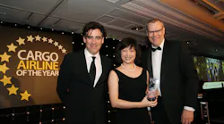 Vivien Lau accepts the award from Nick Platts, Head of Cargo, Heathrow Cargo (category sponsor, right), watched by well-known actor Stephen Mangan (left) who was the event’s host.