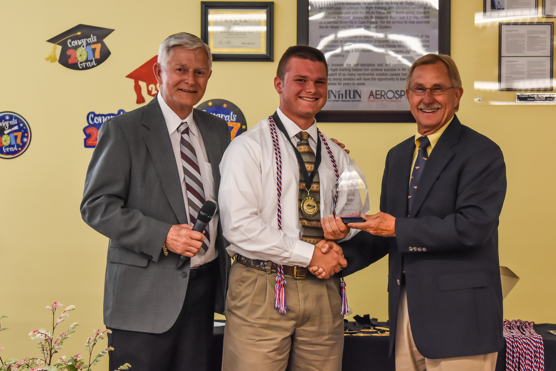 Jensen Houck is pictured with SUN &lsquo;n FUN Chairman of the Board Bob Knight (left) and SUN &lsquo;n FUN President/CEO John &ldquo;Lites&rdquo; Leenhouts (right) at CFAA&rsquo;s end of the year awards ceremony on Monday, May 22, 2017.