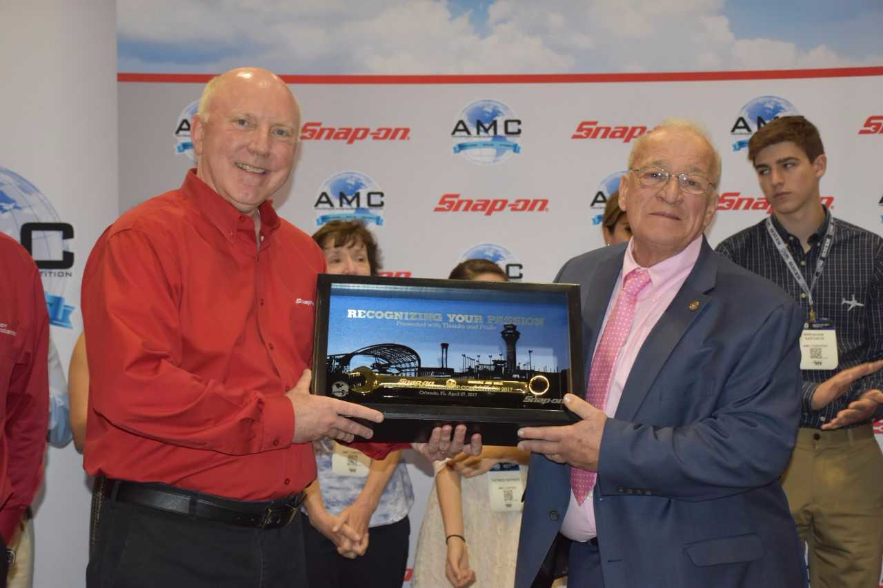 John Goglia receives the Golden Wrench Award from Snap-on's Tom Murray at the AMC in Orlando.